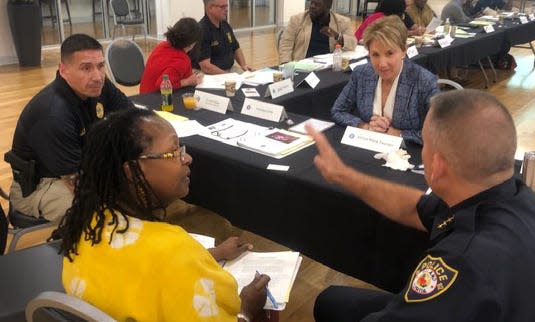 Lorie Fridell, at right, professor of criminology at the University of South Florida, hosts a small-group training for law enforcement. "If you try to screen and find people who don’t have internal bias you aren’t going to have anyone to hire," she said. Instead, you need officers who are aware of and can deal with their bias to make fair decisions.