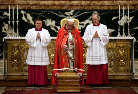 Pope Francis spreads incense over the coffin during the funeral of the former Archbishop of Boston Cardinal Bernard Law in St. Peter's Basilica at the Vatican, December 21, 2017. REUTERS/Max Rossi