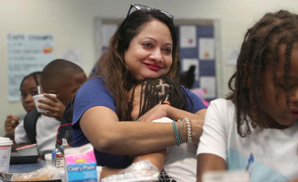 New Volusia County Schools Superintendent Carmen Balgobin gives a crying student a big hug during a breakfast visit on Monday at Palm Terrace Elementary School in Daytona Beach. It was the first day of school for roughly 63,000 Volusia County students.