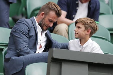 Former footballer David Beckham and his son Romeo after Andy Murray of Britain won his match against Vasek Pospisil of Canada at the Wimbledon Tennis Championships in London