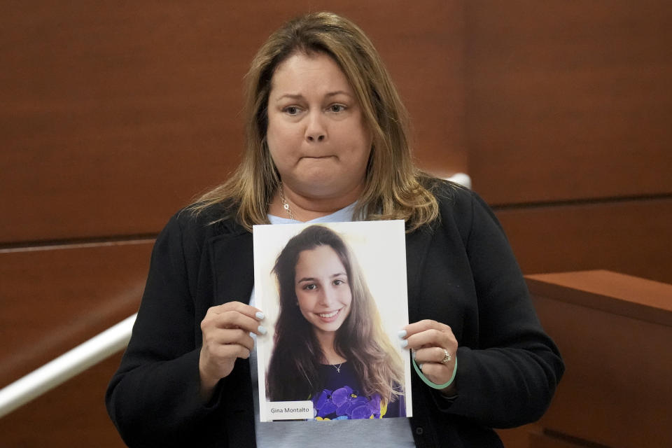 Jennifer Montalto holds a picture of her daughter, Gina, before giving her victim impact statement during the penalty phase of the trial of Marjory Stoneman Douglas High School shooter Nikolas Cruz at the Broward County Courthouse in Fort Lauderdale, Fla., Wednesday, Aug. 3, 2022. Gina Montalto was killed in the 2018 shootings. Cruz previously plead guilty to all 17 counts of premeditated murder and 17 counts of attempted murder in the 2018 shootings. (Amy Beth Bennett/South Florida Sun Sentinel via AP, Pool)