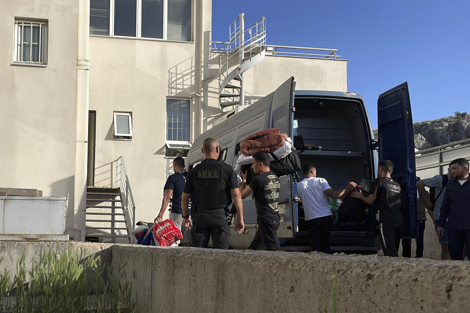 Egyptian shipwreck survivors enter a police station to be processed following their release from prison, in the town of Nafplio, about 136 kilometers (85 miles) southwest of Athens, Greece, Wednesday, May 22, 2024. A Greek court Monday dismissed a case against nine Egyptian defendants accused of causing a shipwreck off the southern coast of Greece last June that killed several hundred migrants travelling from Libya to Italy. The suspects had spent 11 months in pre-trial prison detention. (AP Photo/Derek Gatopoulos)