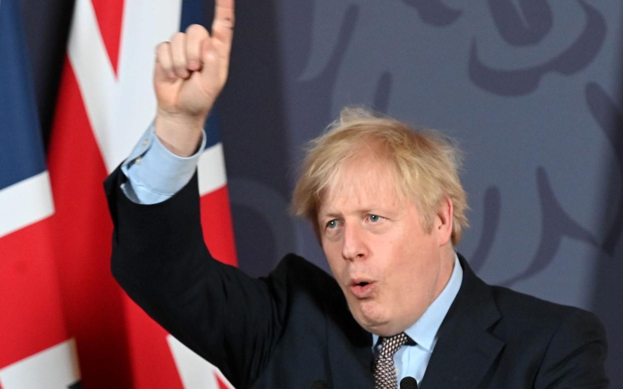 TOPSHOT - Britain's Prime Minister Boris Johnson gestures as he holds a remote press conference to update the nation on the post-Brexit trade agreement, inside 10 Downing Street in central London on December 24, 2020. - Britain said on Thursday, December 24, 2020 an agreement had been secured on the country's future relationship with the European Union, after last-gasp talks just days before a cliff-edge deadline. - Paul GROVER/AFP via Getty Images