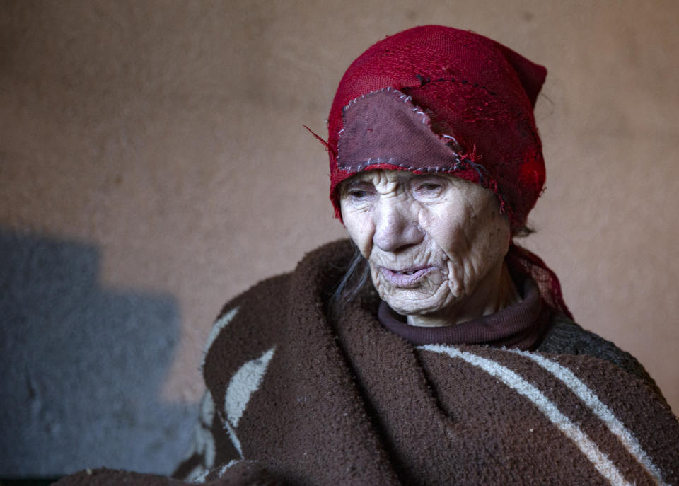 Kosovo Serb Blagica Dicic a lonely 92-year old woman in a remote village of Vaganesh, regularly visited by Kosovo Albanian neighbor Fadil Rama bringing food and groceries in Kosovo on Thursday, Nov. 19, 2020, abandoned by all her former ethnic Serb neighbors. (AP Photo/Visar Kryeziu)