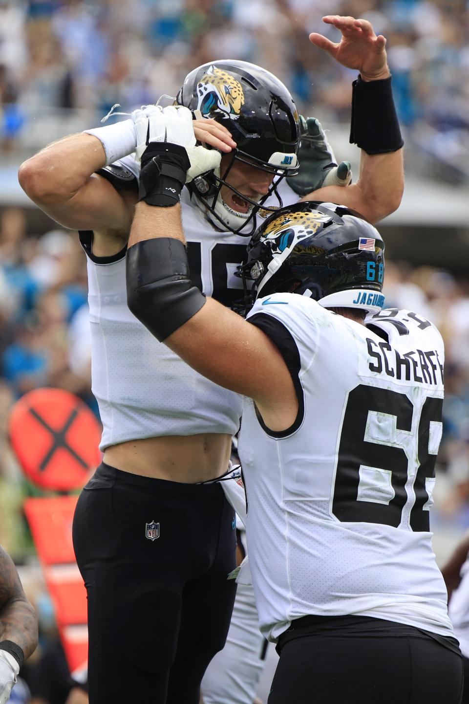 Jacksonville Jaguars quarterback Trevor Lawrence (16) celebrates his touchdown pass with teammate guard Brandon Scherff (68) during the third quarter Sunday, Sept. 18, 2022 at TIAA Bank Field in Jacksonville. The Jacksonville Jaguars blanked the Indianapolis Colts 24-0. [Corey Perrine/Florida Times-Union]