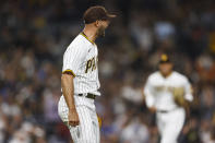 San Diego Padres starting pitcher Nick Martinez celebrates after second baseman Jake Cronenworth threw to first base for the third out against the Milwaukee Brewers during the fourth inning of a baseball game Monday, May 23, 2022, in San Diego. (AP Photo/Mike McGinnis)