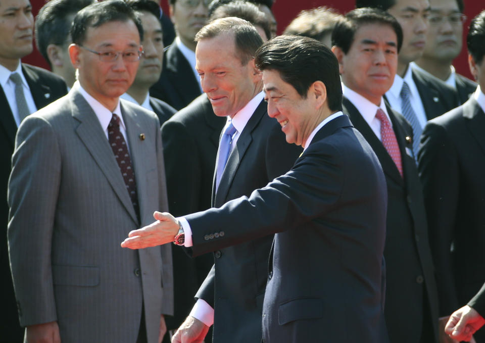 Australian Prime Minister Tony Abbott is escorted by Japanese Prime Minister Shinzo Abe during a welcome ceremony at Akasaka State Guest House in Tokyo, Monday, April 7, 2014. (AP Photo/Koji Sasahara)