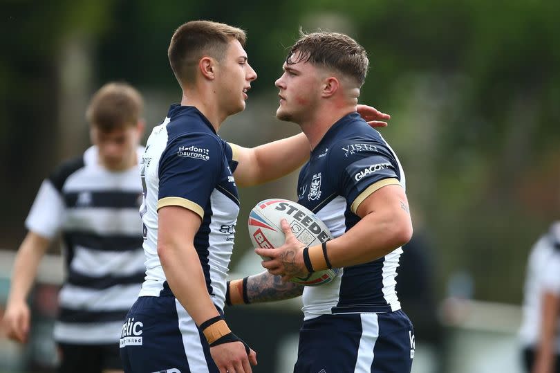 Denive Balmforth celebrates a Hull FC try with Sully Medforth.