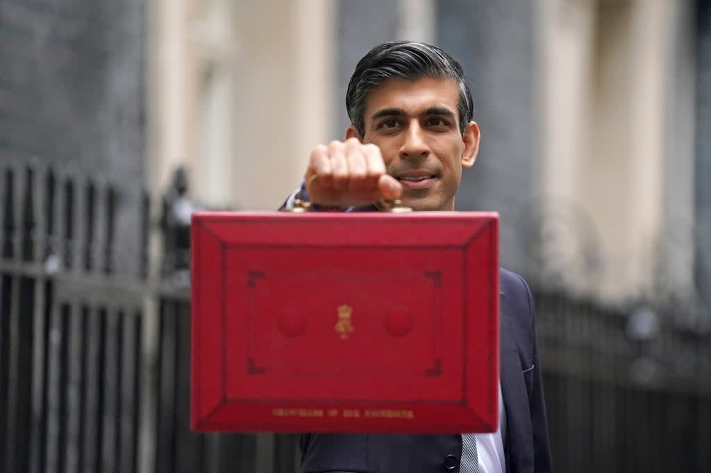 Chancellor of the Exchequer Rishi Sunak holds his ministerial ‘Red Box’ as he stands with his ministerial team and Parliamentary Private Secretaries, outside 11 Downing Street, London, before delivering his Budget to the House of Commons. Picture date: Wednesday October 27, 2021. (PA Wire)