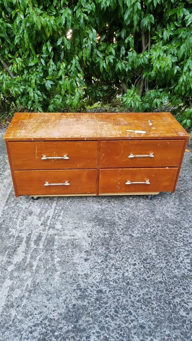 A before image of a scratched four-drawer dresser