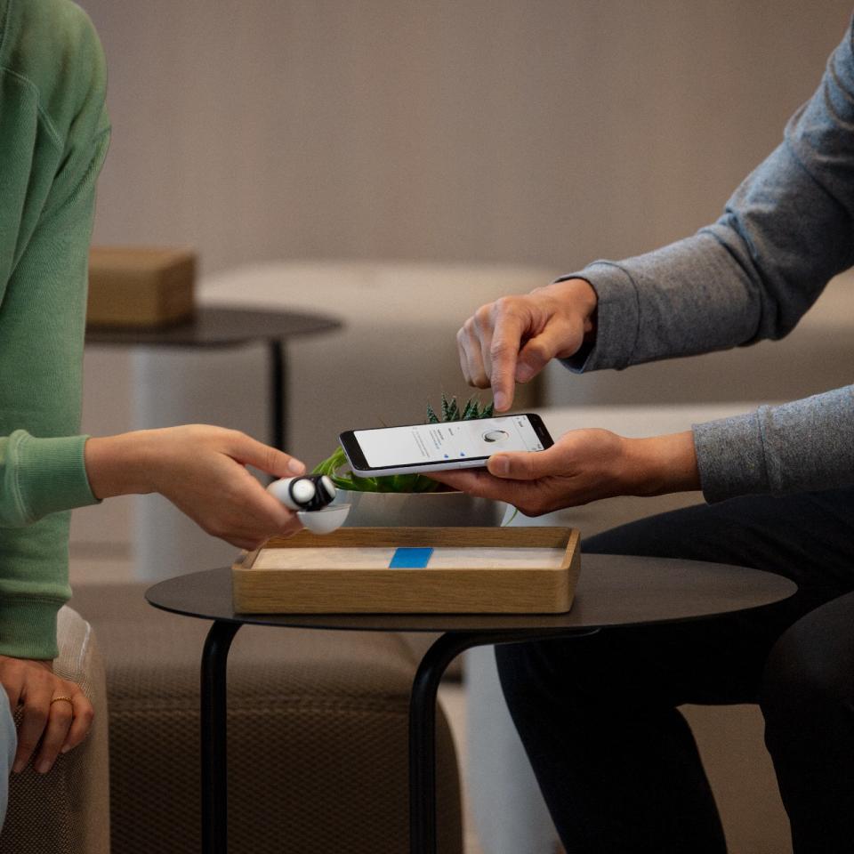 <p>Google Store Chelsea. A close-up of a person holding a phone pointing at the screen while another person across a small table holds a set of Pixel Buds.</p> 