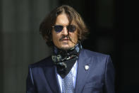 Actor Johnny Depp arrives at the High Court for a hearing in his libel case, in London, Friday, July 24, 2020. Depp is suing News Group Newspapers, publisher of The Sun, and the paper's executive editor, Dan Wootton, over an April 2018 article that called him a "wife-beater." The Sun's defense relies on a total of 14 allegations by his ex-wife, actress Amber Heard of Depp's violence. He strongly denies all of them. (Aaron Chown/PA via AP)