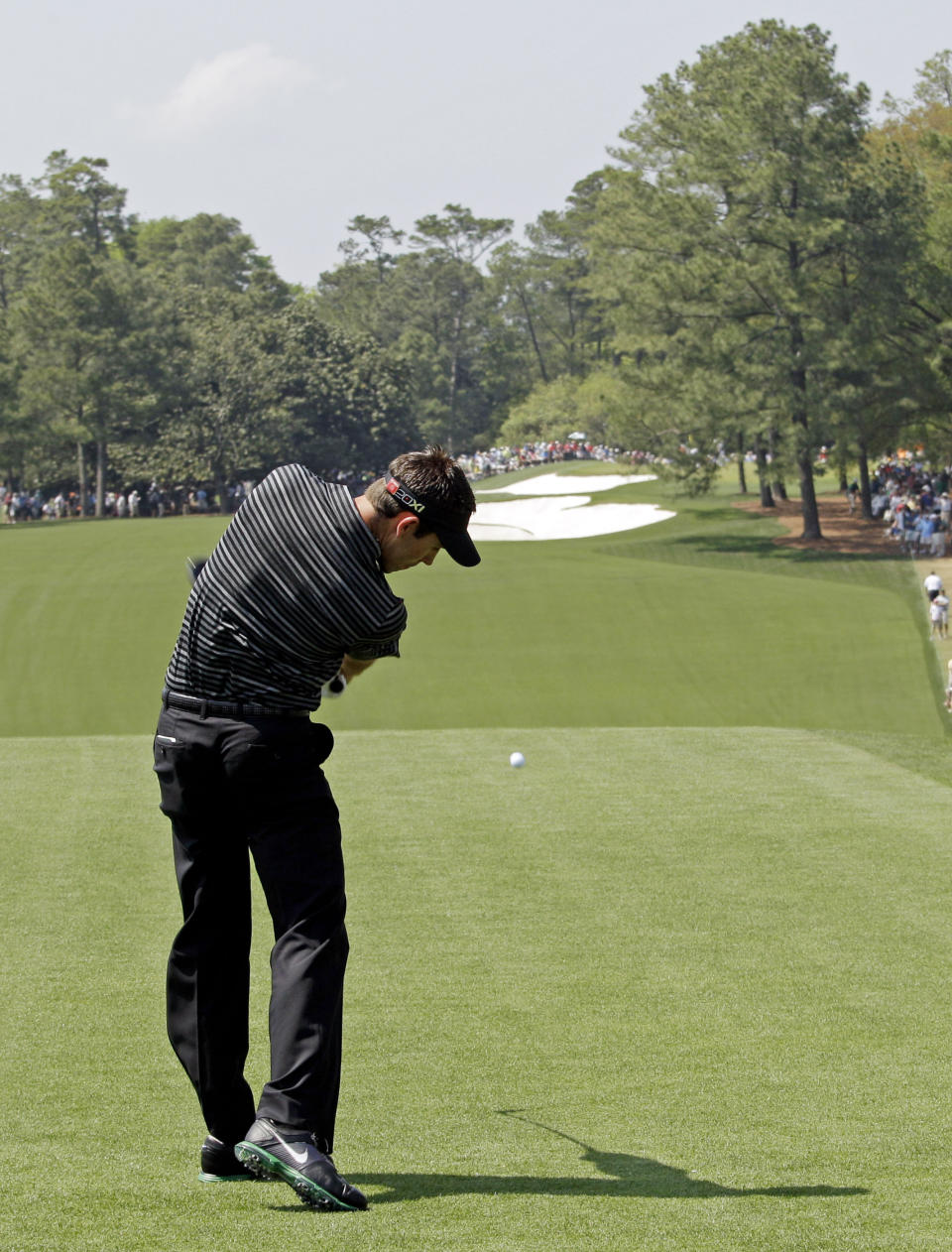 FILE - Charl Schwartzel of South Africa tees off on the first hole during the final round of the Masters golf tournament Sunday, April 10, 2011, in Augusta, Ga. Schwartzel made one of the more remarkable birdies on the hole known as "Tea Olive." (AP Photo/Charlie Riedel, File)