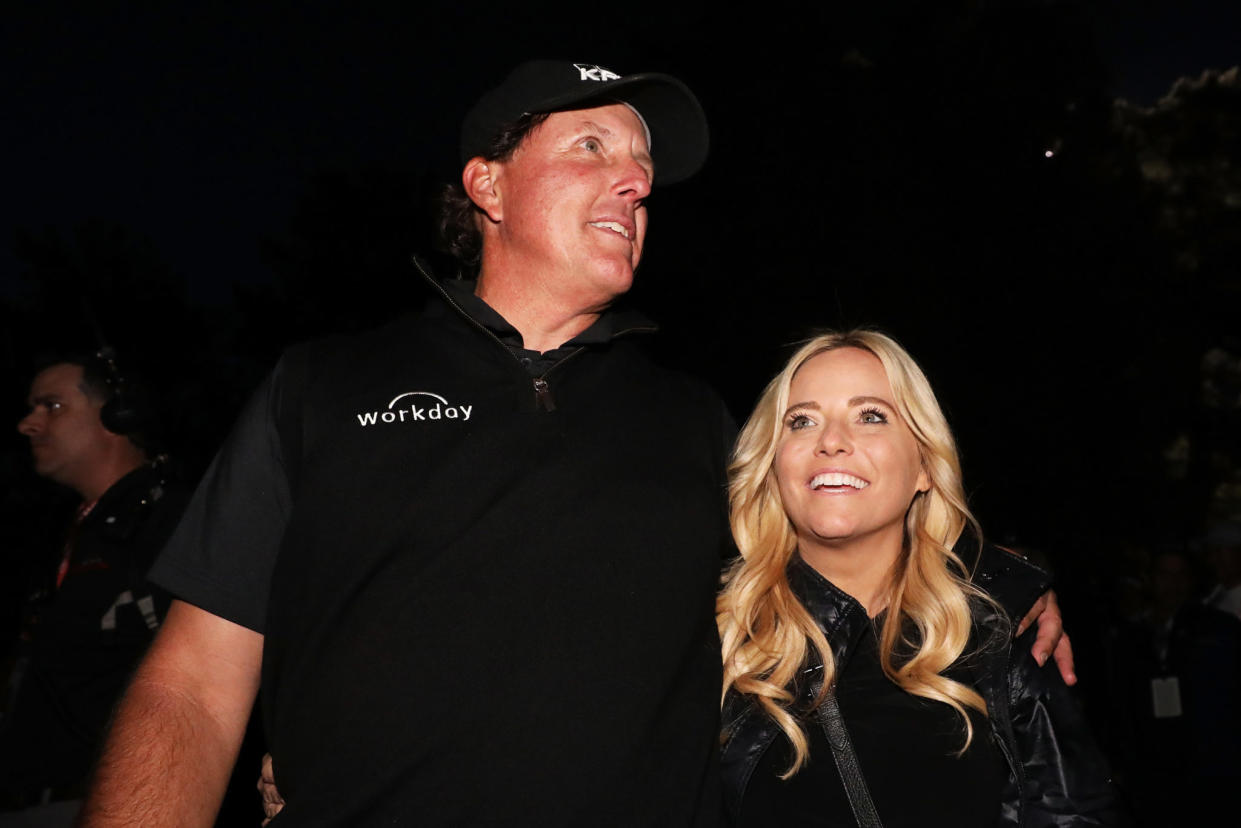 Phil Mickelson posing for a photo with his wife.