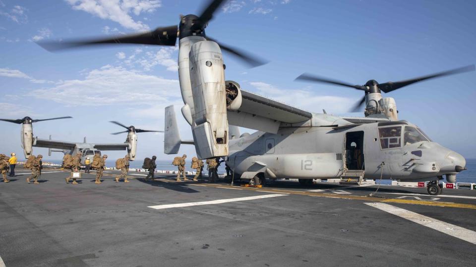 Marines from the 13th Marine Expeditionary Unit prepare to board an MV-22 Osprey on the amphibious assault ship Makin Island in 2022. (MC3 Kendra Helmbrecht/U.S. Navy)