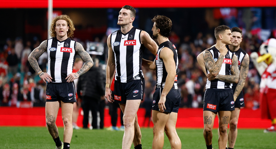 Collingwood players look dejected after their brutal three-point loss to AFL ladder-leader Sydney. Pic: Getty 
