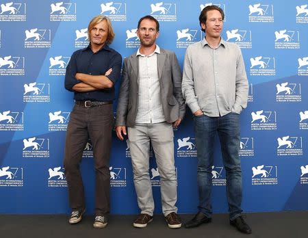 Actors Reda Kateb (R) and Viggo Mortensen (L) pose with director David Oelhoffen during the photo call for the movie "Loin des hommes" at the 71st Venice Film Festival August 31, 2014. REUTERS/Tony Gentile