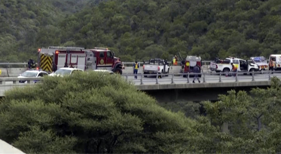 In this image taken from video provided by eNCA, a bus carrying worshippers headed to an Easter festival plunged off a bridge on a mountain pass and burst into flames in Limpopo, South Africa, on Thursday, March 28, 2024, killing multiple people, authorities said. (eNCA via AP)