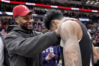 Milwaukee Bucks' Damian Lillard, left, grabs the shoulders of former teammate Portland Trail Blazers' Anfernee Simons after an NBA basketball game between the Chicago Bulls and the Trail Blazers Monday, March 18, 2024, in Chicago. (AP Photo/Charles Rex Arbogast)