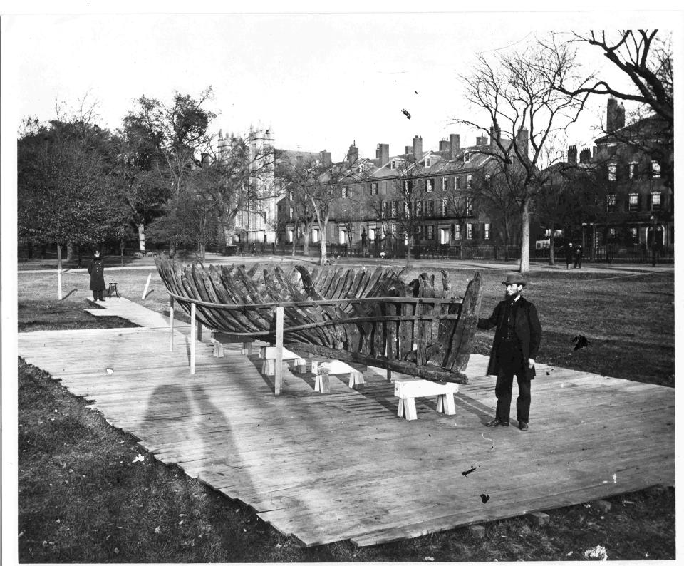 This 1865 photo provided by the Pilgrim Hall Museum, shows Leander Cosby, of Orleans, Mass., right, standing with remains of the 1626 shipwreck Sparrow-hawk, on the Boston Common, in Boston. Cosby was an early visitor to the wreck site when it was uncovered in the 1860s, and helped excavate and preserve the vessel. (Josiah Johnson Hawes/Pilgrim Hall Museum via AP)