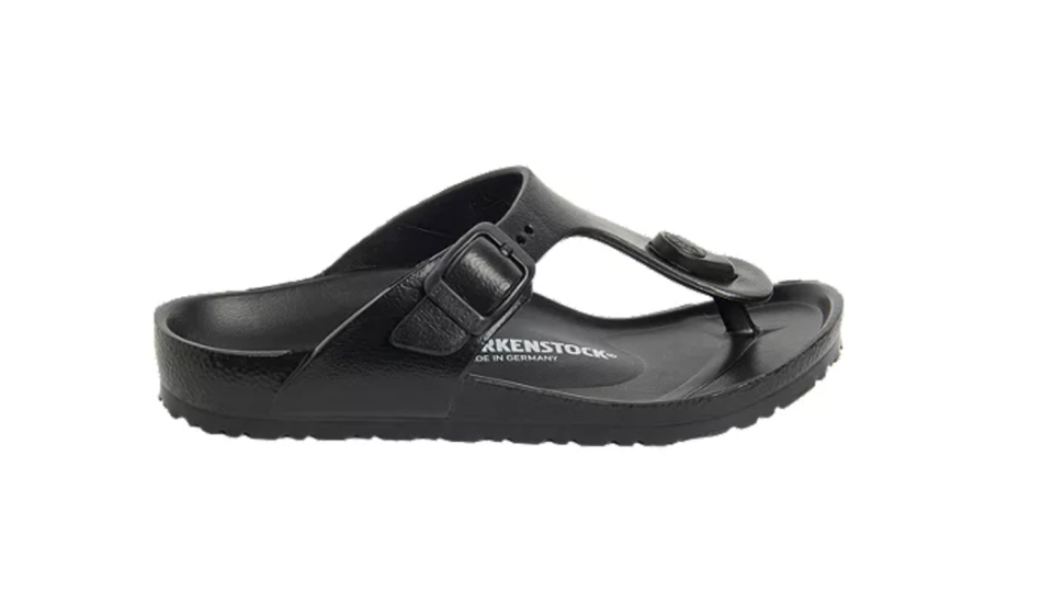 Black Birkenstock women's sandals with toe separator and buckle.