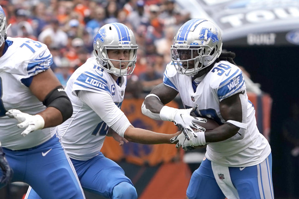 Detroit Lions quarterback Jared Goff, left, hands off to running back Jamaal Williams during the first half of an NFL football game against the Chicago Bears Sunday, Oct. 3, 2021, in Chicago. (AP Photo/David Banks)