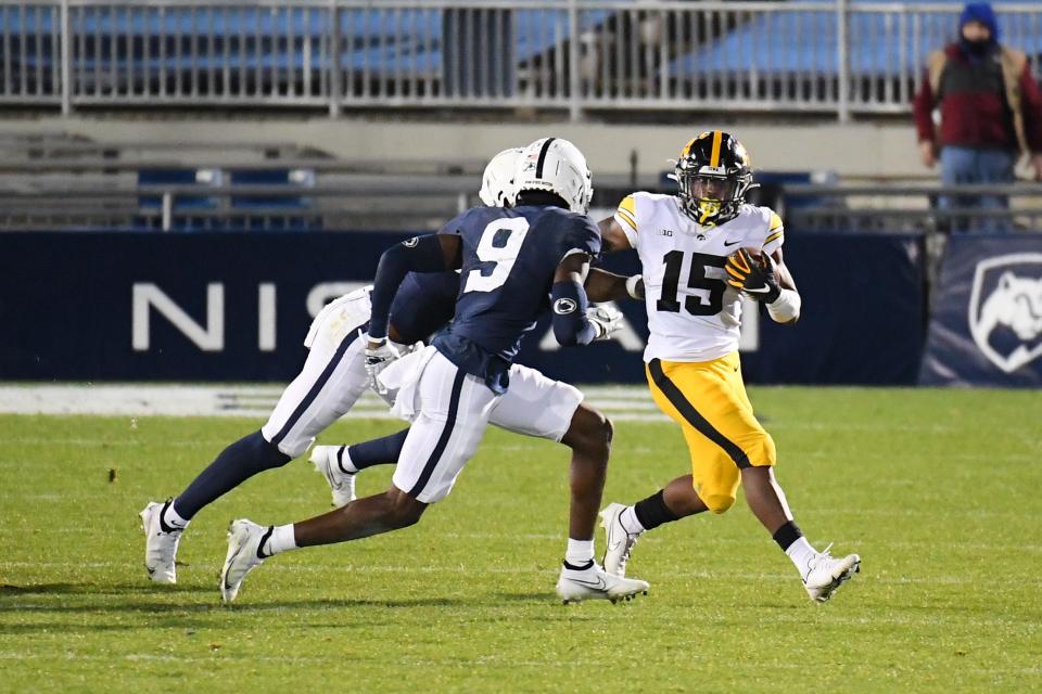 Iowa running back Tyler Goodson (15) runs with the ball as Penn State cornerback Joey Porter Jr. (9) defends during their game in 2020 at Beaver Stadium.