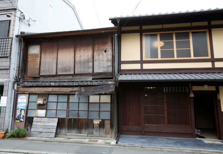 Kyoto native Yoshinori Murase's "machiya" townhouse (R), which was restored with the help of a "machiya" loan from Bank of Kyoto, is pictured with an empty "machiya" townhouse in Kyoto, Japan, June 26, 2016. REUTERS/Lisa Twaronite