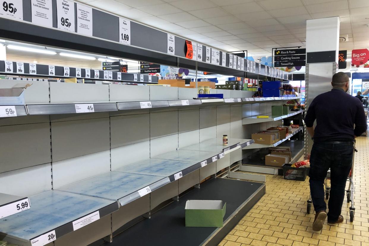 A shopper walks past empty shelves in a Lidl store in Wallington in March at the peak of the pandemic: Getty Images