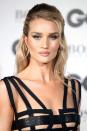 <p>Rosie Huntington-Whiteley's half-up hairstyle is neat and polished, save for a few wisps of hair framing her face for a more casual look. </p>