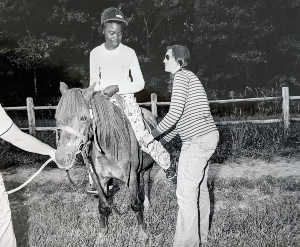 In a photo from 1979, Regina Kear Reid, right, helps a riding student. As part of her master's thesis, the Cocoa resident set up a handicapped riding program in Greenville, North Carolina.