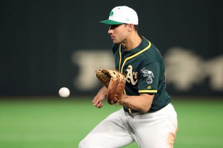 FILE PHOTO: Mar 17, 2019; Tokyo, Japan; Oakland Athletics first baseman Matt Olson (28) catches a bouncing ball to record an out during the fourth inning against the Nippon Ham Fighters at Tokyo Dome. Mandatory Credit: Darren Yamashita-USA TODAY Sports