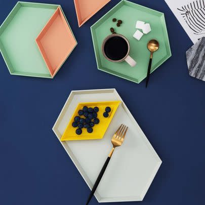 A colorful four-piece geometric tray set you can stack up to organize all your pretty little trinkets