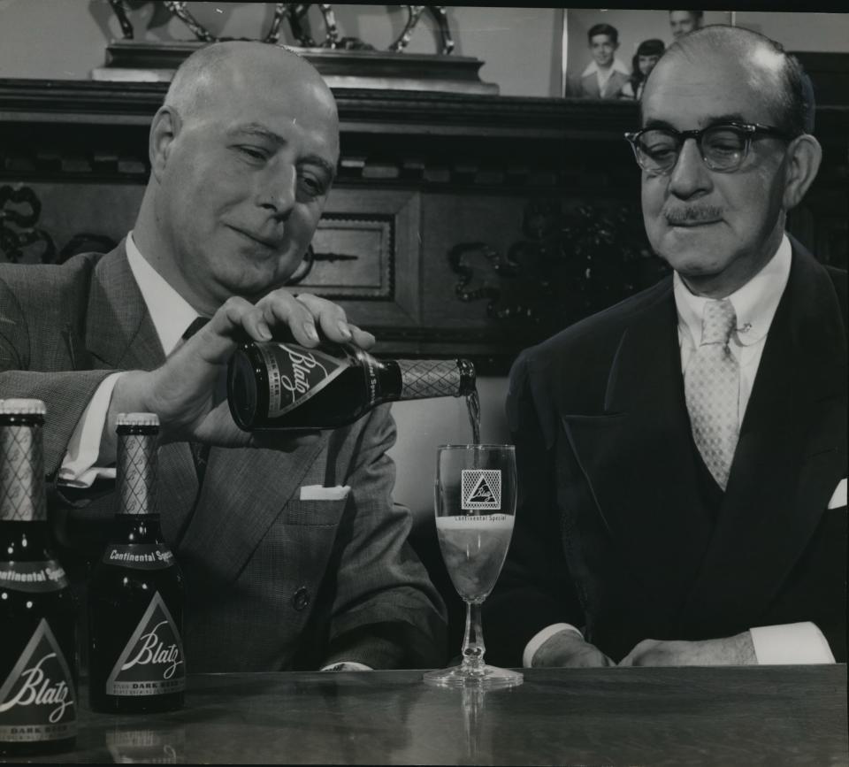 Frank C. Verbest, president of Blatz Brewing Co., pours a glass of the Milwaukee brewery's new dark beer, Blatz Continental Special, for Louis E Wheeler, Blatz's general sales director, in this 1953 photo.