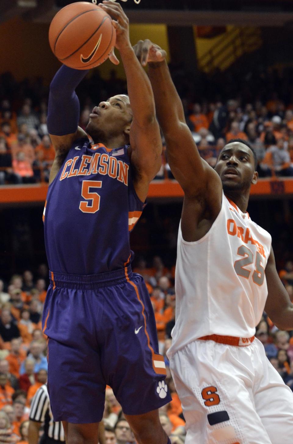 Clemson's Jaron Blossomgame is fouled by Syracuse's Rakeem Christmas, right, during the first half of an NCAA college basketball game in Syracuse, N.Y., Sunday, Feb. 9, 2014. (AP Photo/Kevin Rivoli)