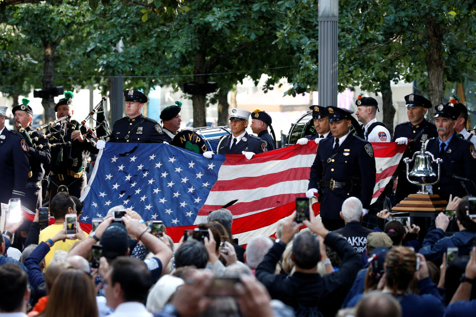 <p>Police and Fire Department officers hold an American flag that flew over the World Trade Center at the National 911 Memorial and Museum during ceremonies marking the 16th anniversary of the Sept. 11, 2001, attacks in New York, Sept. 11, 2017. (Photo: Brendan McDermid/Reuters) </p>