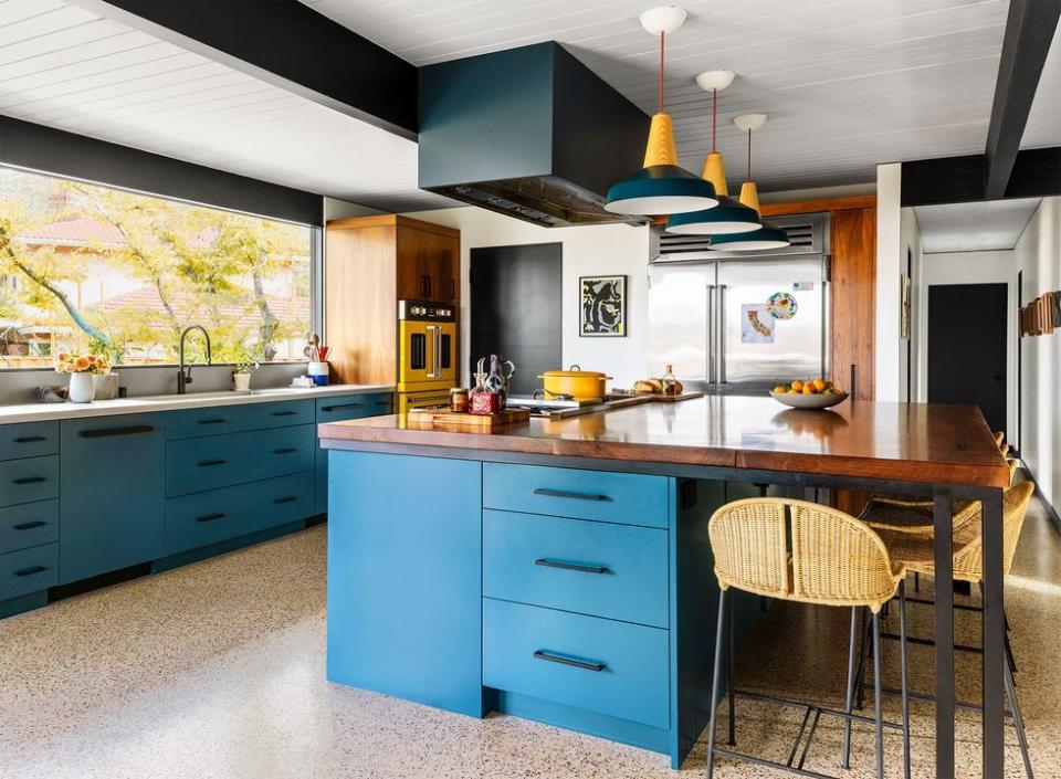 a kitchen with blue cabinets