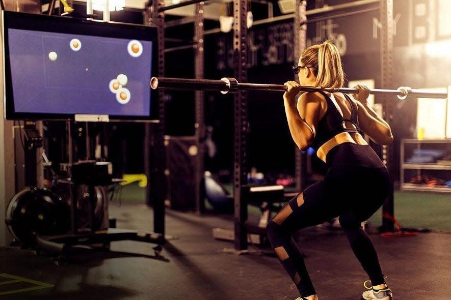 woman standing using neurotracker