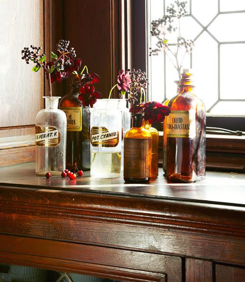 <p>Haunted pharmacy theme? Fun! Vintage apothecary bottles serve double-duty as vases for dried blooms. See more at <a href="http://www.goodhousekeeping.com/holidays/halloween-ideas/g421/halloween-decorating-ideas-1007/" rel="nofollow noopener" target="_blank" data-ylk="slk:Good Housekeeping;elm:context_link;itc:0;sec:content-canvas" class="link "><em>Good Housekeeping</em></a>.</p><p><a class="link " href="https://www.amazon.com/Vintage-Design-Embossed-Bottles-Apothecary/dp/B0716TYHZT/?tag=syn-yahoo-20&ascsubtag=%5Bartid%7C10057.g.2554%5Bsrc%7Cyahoo-us" rel="nofollow noopener" target="_blank" data-ylk="slk:BUY NOW;elm:context_link;itc:0;sec:content-canvas">BUY NOW</a> <strong><em>Vintage Design Glass Bottles, $14</em></strong></p>