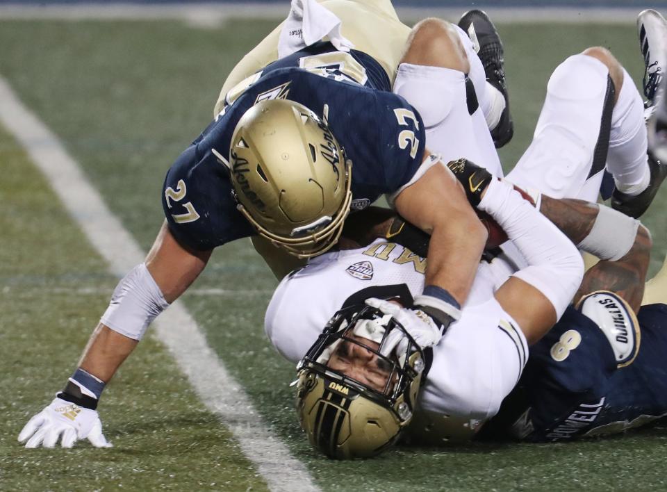 Akron's Bubba Arslanian and Jaylen Kelly-Powell team up to stop Western Michigan's Skyy Moore on a reception, Wednesday, Nov. 4, 2020.