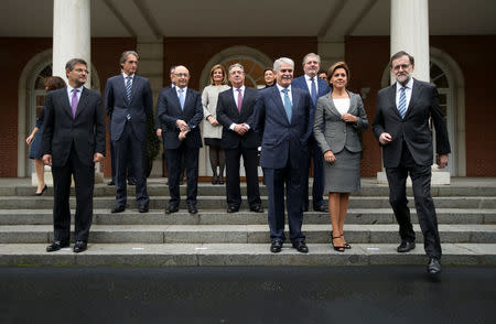 Spanish Prime Minister Mariano Rajoy (R) steps into position for a family photo with his new cabinet after winning a parliamentary confidence vote for a second term ending 10 months of political paralysis that included two inconclusive elections, at the Moncloa Palace in Madrid, November 4, 2016. REUTERS/Sergio Perez