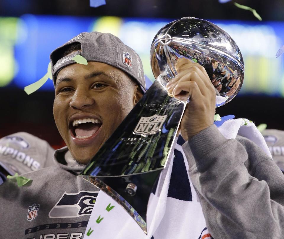 Seattle Seahawks' Malcolm Smith holds the Vince Lombardi Trophy after the NFL Super Bowl XLVIII football game against the Denver Broncos Sunday, Feb. 2, 2014, in East Rutherford, N.J. The Seahawks won 43-8. (AP Photo/Matt Slocum)
