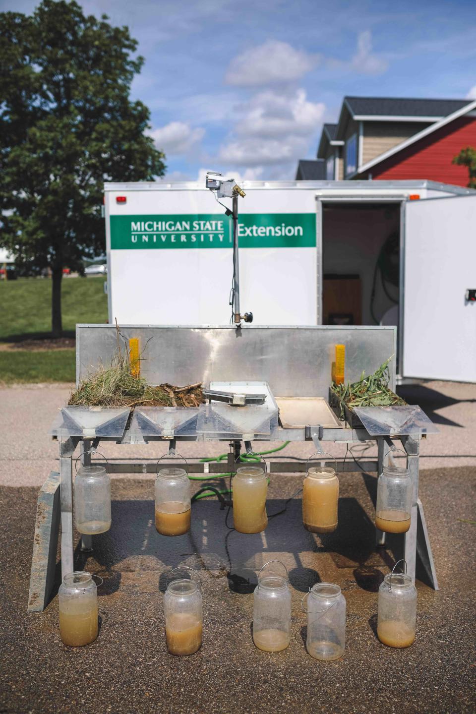 A rainfall simulator demonstrates how rain water interacts with different types of soil preparations.