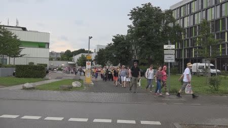 A screen grab taken from video footage shows people walking out of a building, following a shooting rampage at the Olympia shopping mall in Munich, Germany July 22, 2016. REUTERS/Non-stop News/Handout via Reuters TV