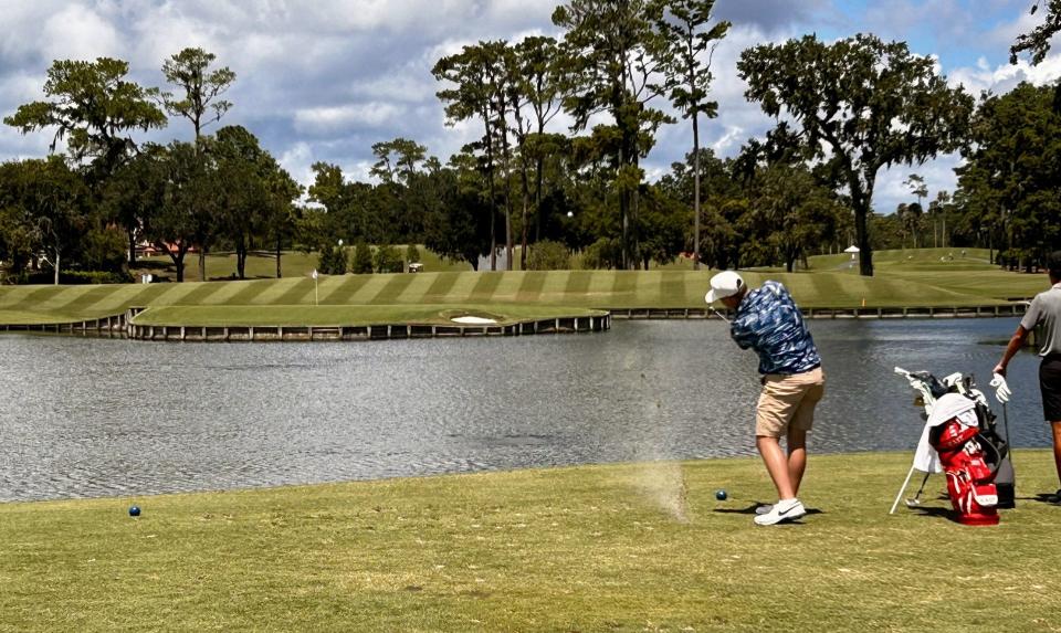 Phillip Dunham of Ponte Vedra Beach follows through on his tee shot at the par-3 17th hole of the Players Stadium Course at TPC Sawgrass during the first round of the Junior Players Championship on Aug. 30.