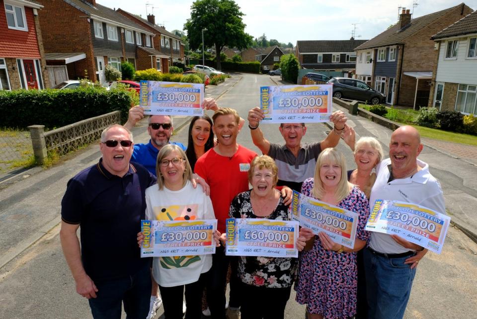 Eight neighbours in Arnold, Nottinghamshire, celebrating after winning a combined £270,000 with People’s Postcode Lottery on Sunday (PA)