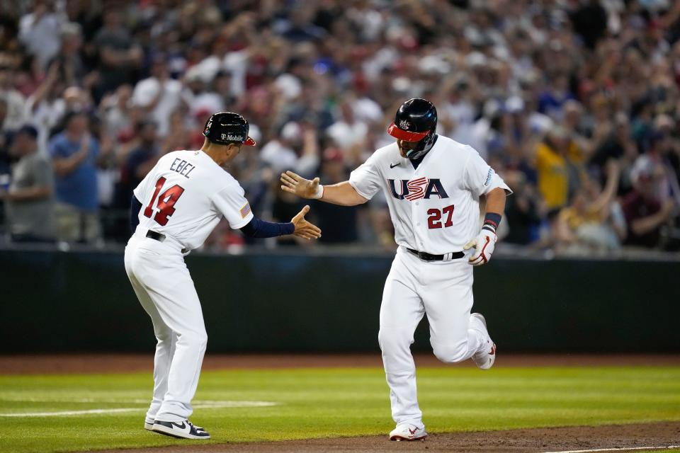 United States' Mike Trout, right, celebrates with third base coach Dino Ebel after hitting a three-run home run against Canada during the World Baseball Classic in Phoenix, on March 13, 2023.