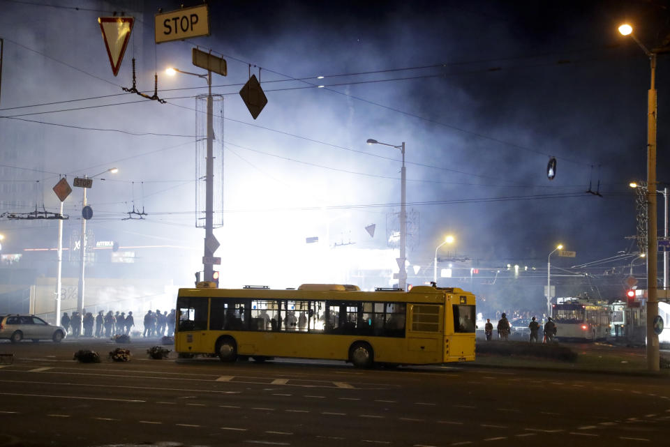 Police police use flashbang grenades to disperse protesters during a mass rally following presidential elections in Minsk, Belarus, Monday, Aug. 10, 2020. Thousands of people have protested in Belarus for a second straight night after official results from weekend elections gave an overwhelming victory to authoritarian President Alexander Lukashenko, extending his 26-year rule. A heavy police contingent blocked central squares and avenues, moving quickly to disperse protesters and detained dozens. (AP Photo/Sergei Grits)