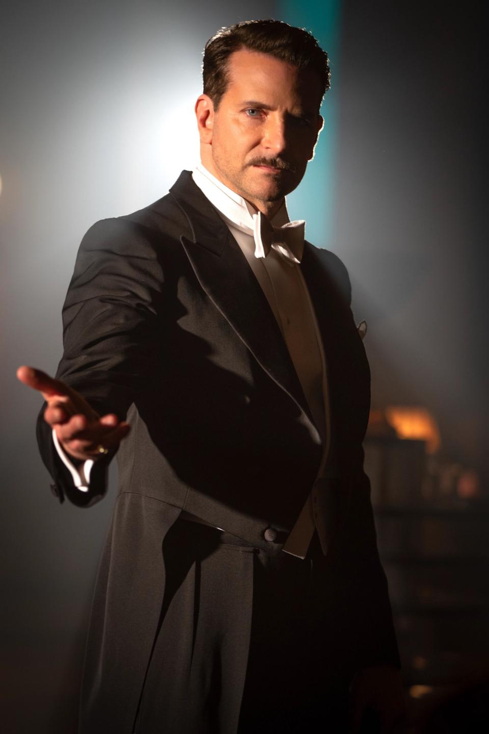 Cooper wearing a tux, mustache, ready to perform a magical act