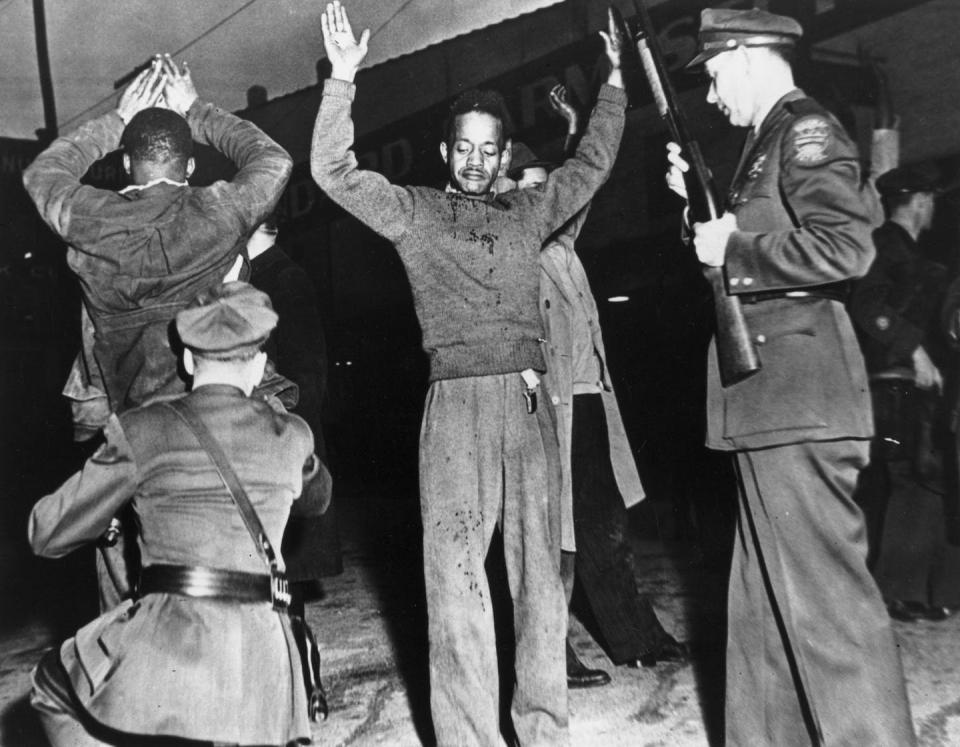 Police searching Black men during the riots in Columbia, Tenn., on Feb. 27, 1946. <a href="https://www.gettyimages.com/detail/news-photo/police-searching-rioteers-during-the-black-riots-in-news-photo/3428128?adppopup=true" rel="nofollow noopener" target="_blank" data-ylk="slk:Fox Photos/Getty Images;elm:context_link;itc:0;sec:content-canvas" class="link ">Fox Photos/Getty Images</a>